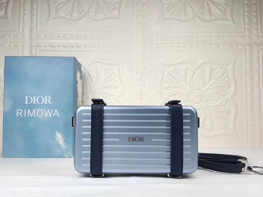 Presentation image of the blue Dior x Rimowa aluminum clutch