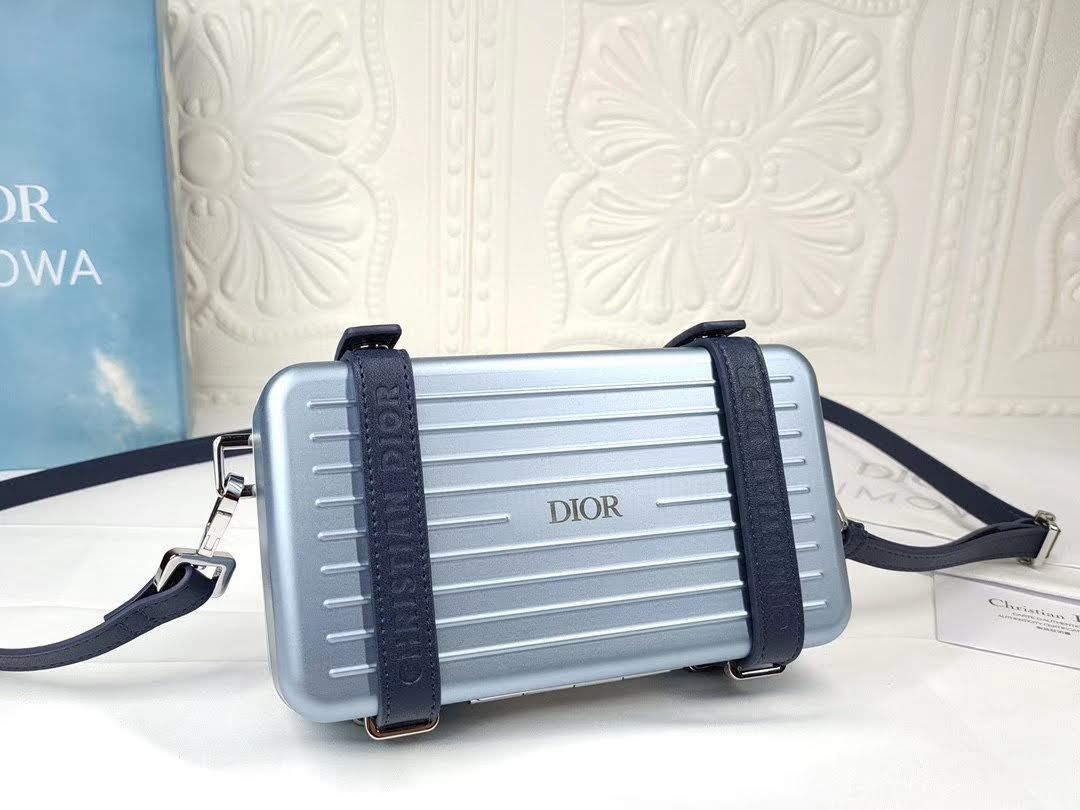 Presentation image of the blue Dior x Rimowa aluminum clutch