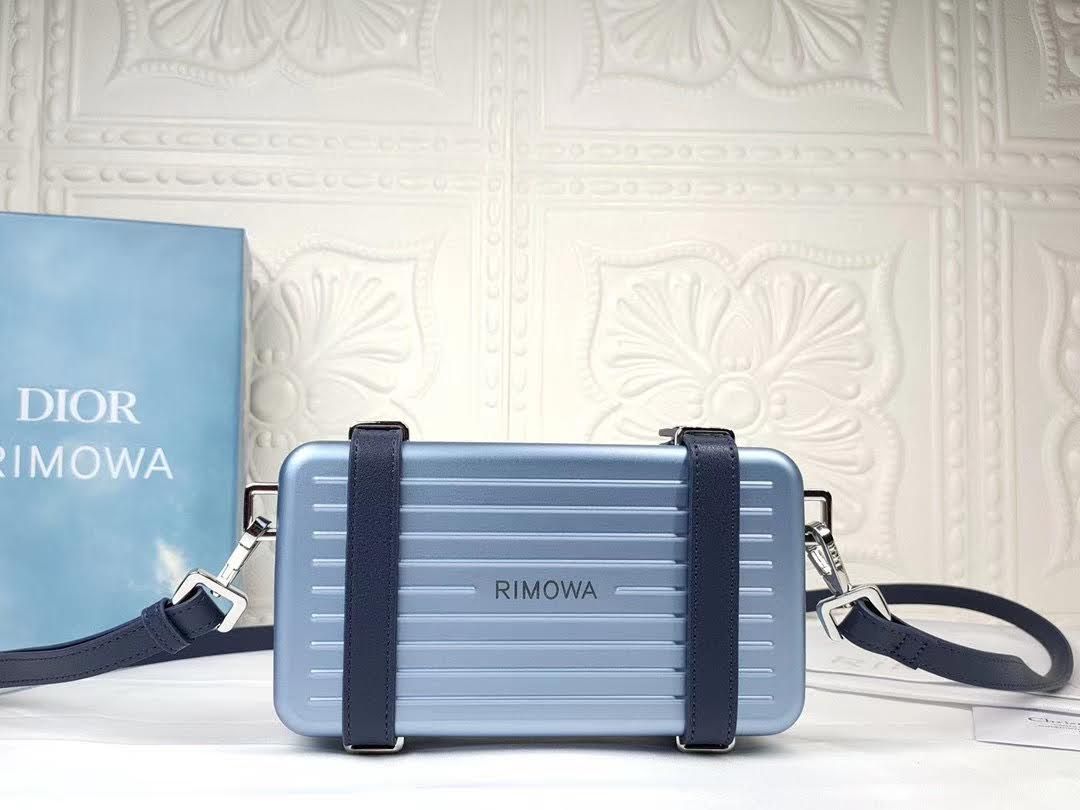 Presentation image of the blue Dior x Rimowa aluminum clutch