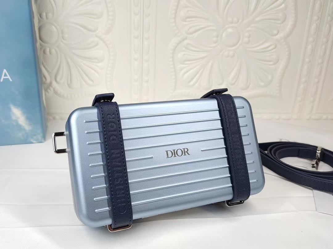 Presentation image of the blue Dior x Rimowa aluminum clutch