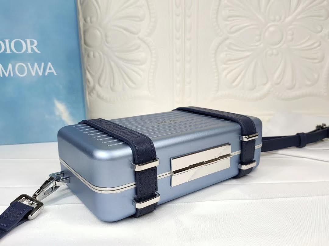 Presentation image of the blue Dior x Rimowa aluminum clutch bottom