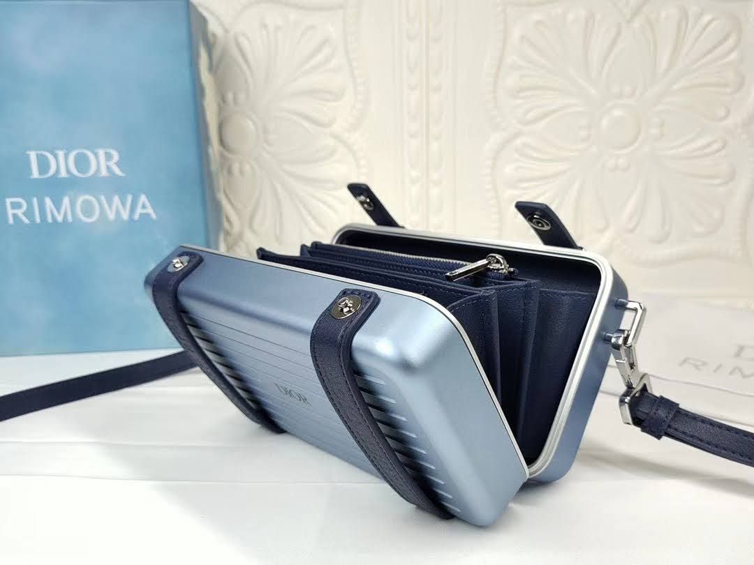 Presentation image of the opened blue Dior x Rimowa aluminum clutch