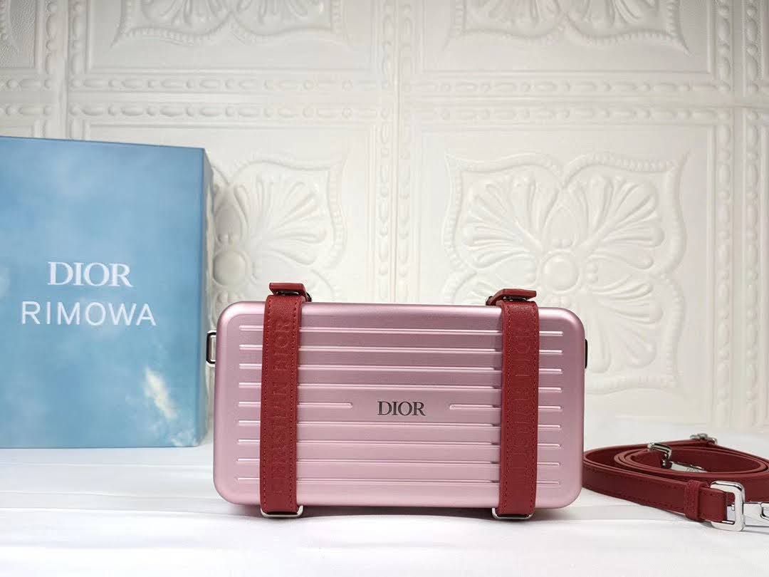 Presentation image of the pink Dior x Rimowa aluminum clutch