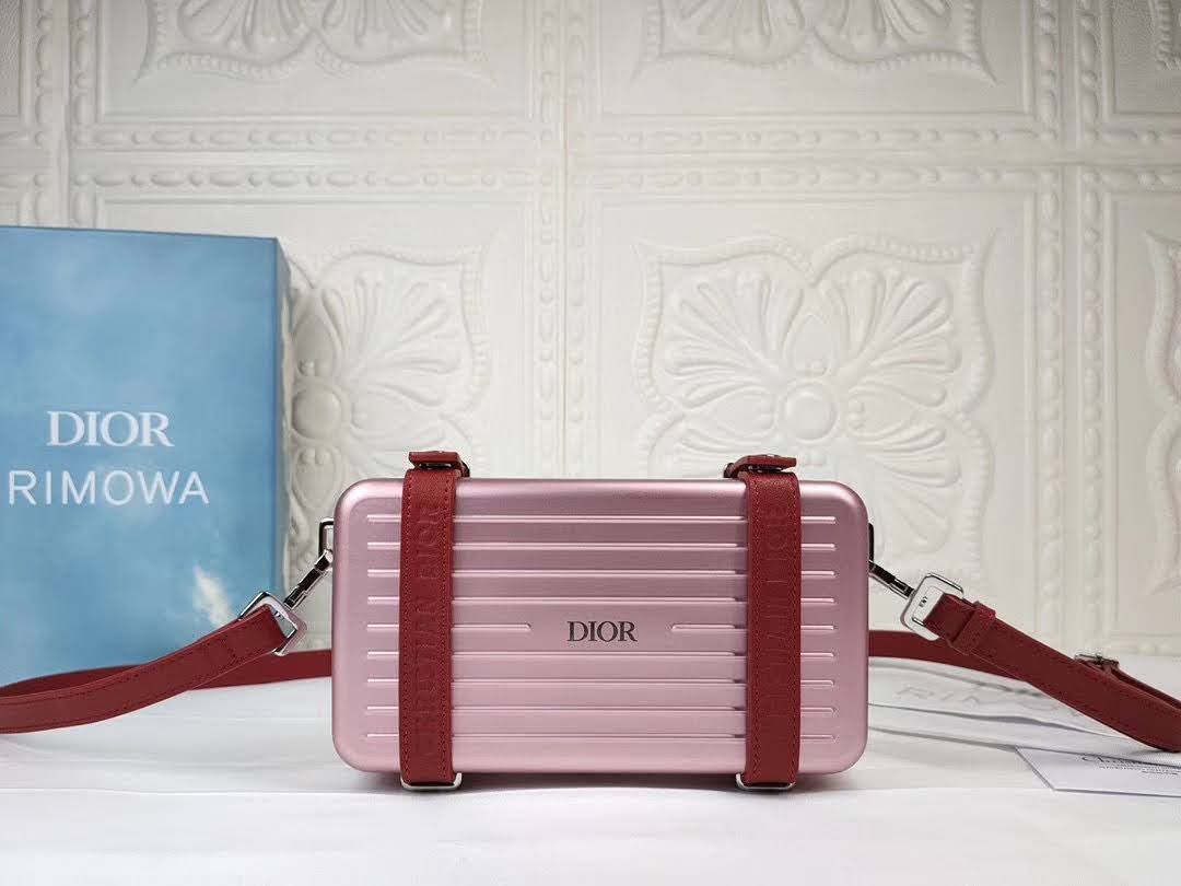 Presentation image of the pink Dior x Rimowa aluminum clutch