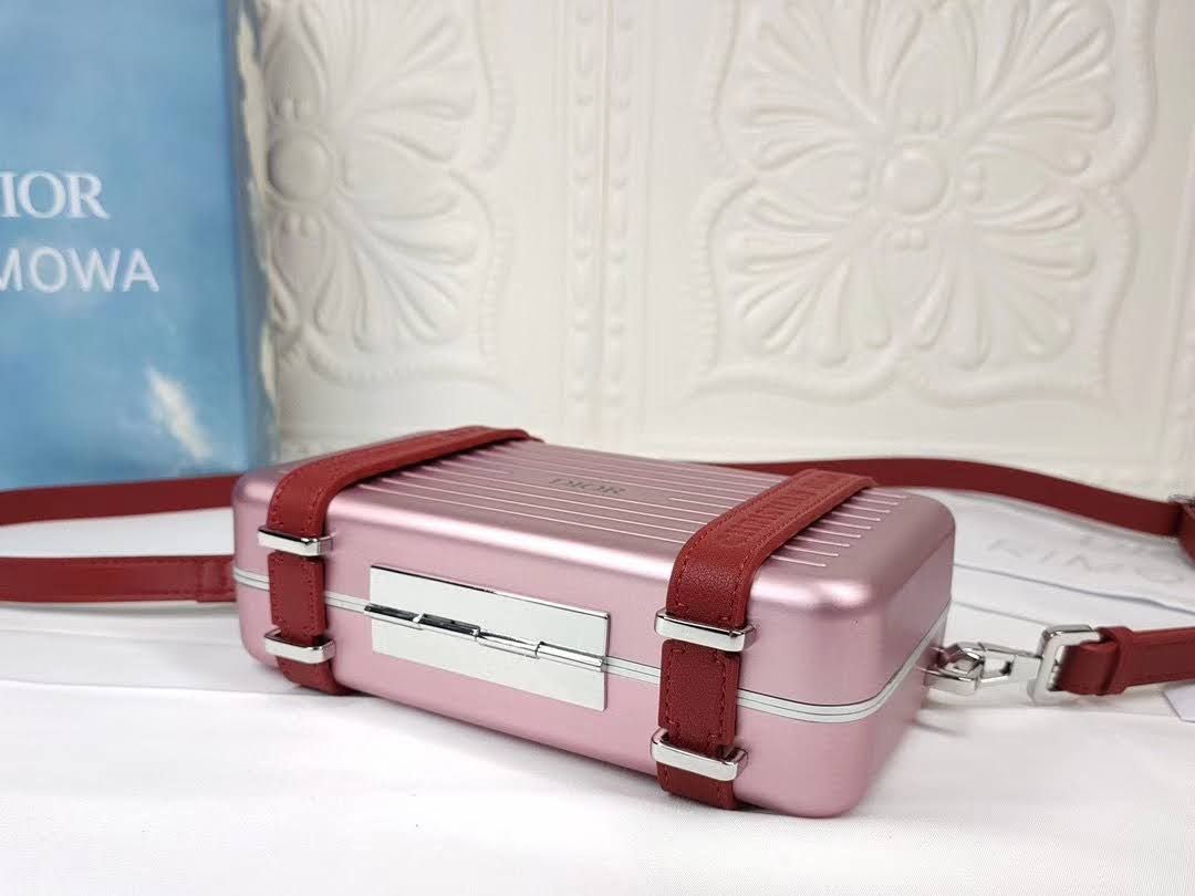 Presentation image of the pink Dior x Rimowa aluminum clutch bottom