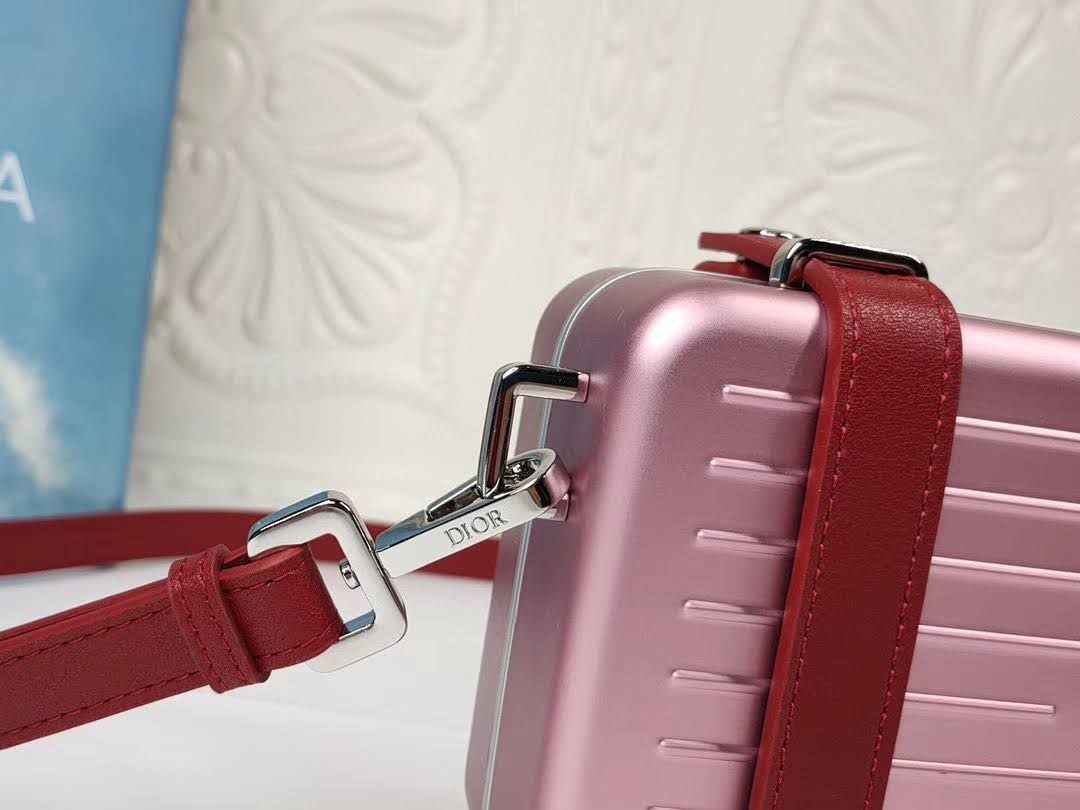 Presentation image of the pink Dior x Rimowa aluminum clutch details