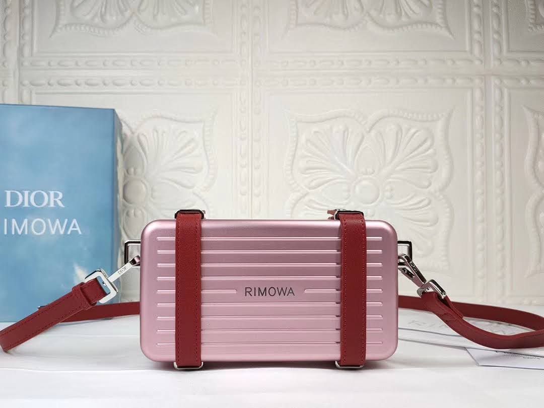 Presentation image of the pink Dior x Rimowa aluminum clutch