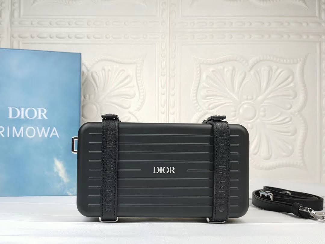 Presentation image of the black Dior x Rimowa aluminum clutch