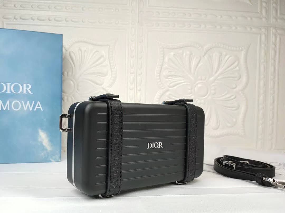 Presentation image of the black Dior x Rimowa aluminum clutch