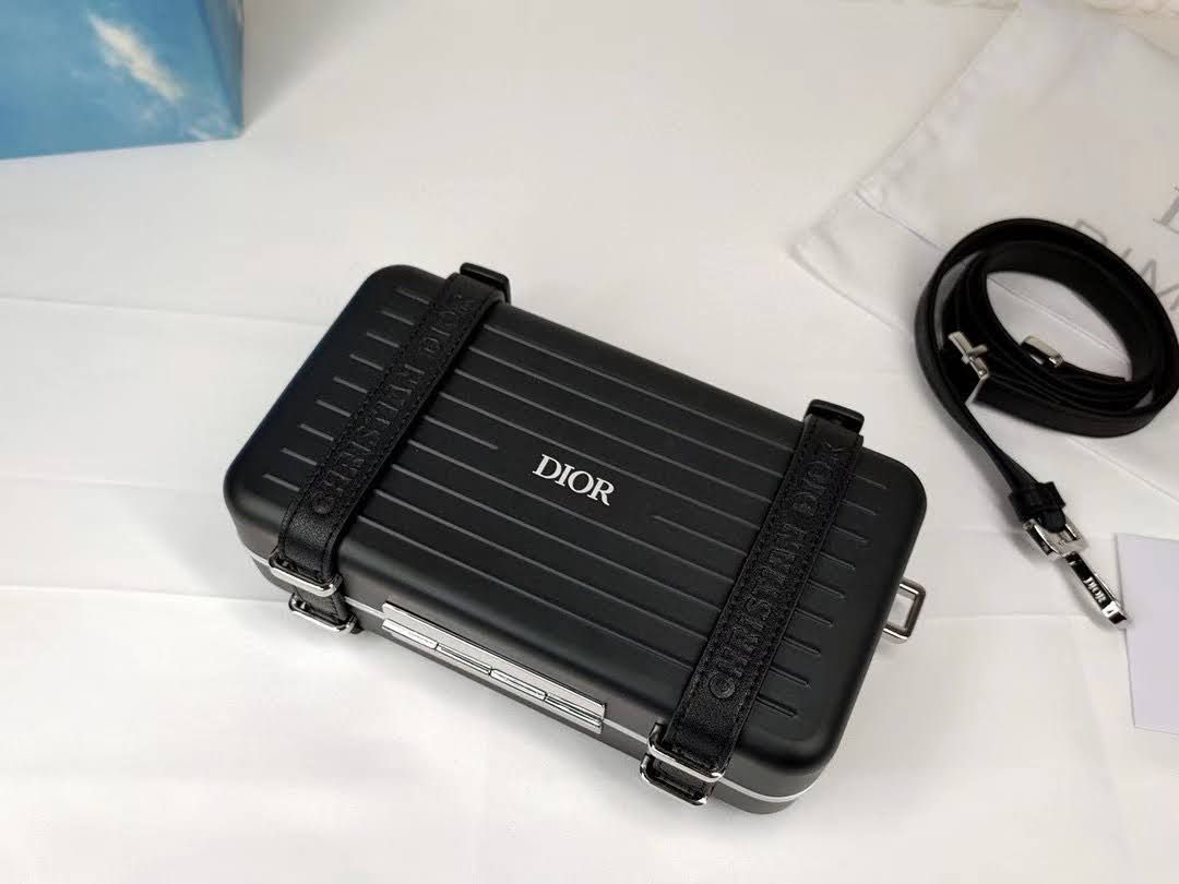 Presentation image of the black Dior x Rimowa aluminum clutch