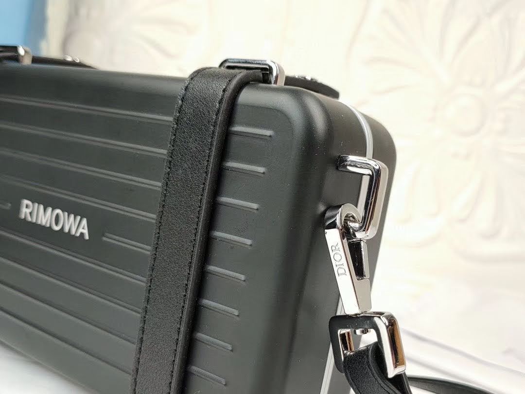 Presentation image of the black Dior x Rimowa aluminum clutch