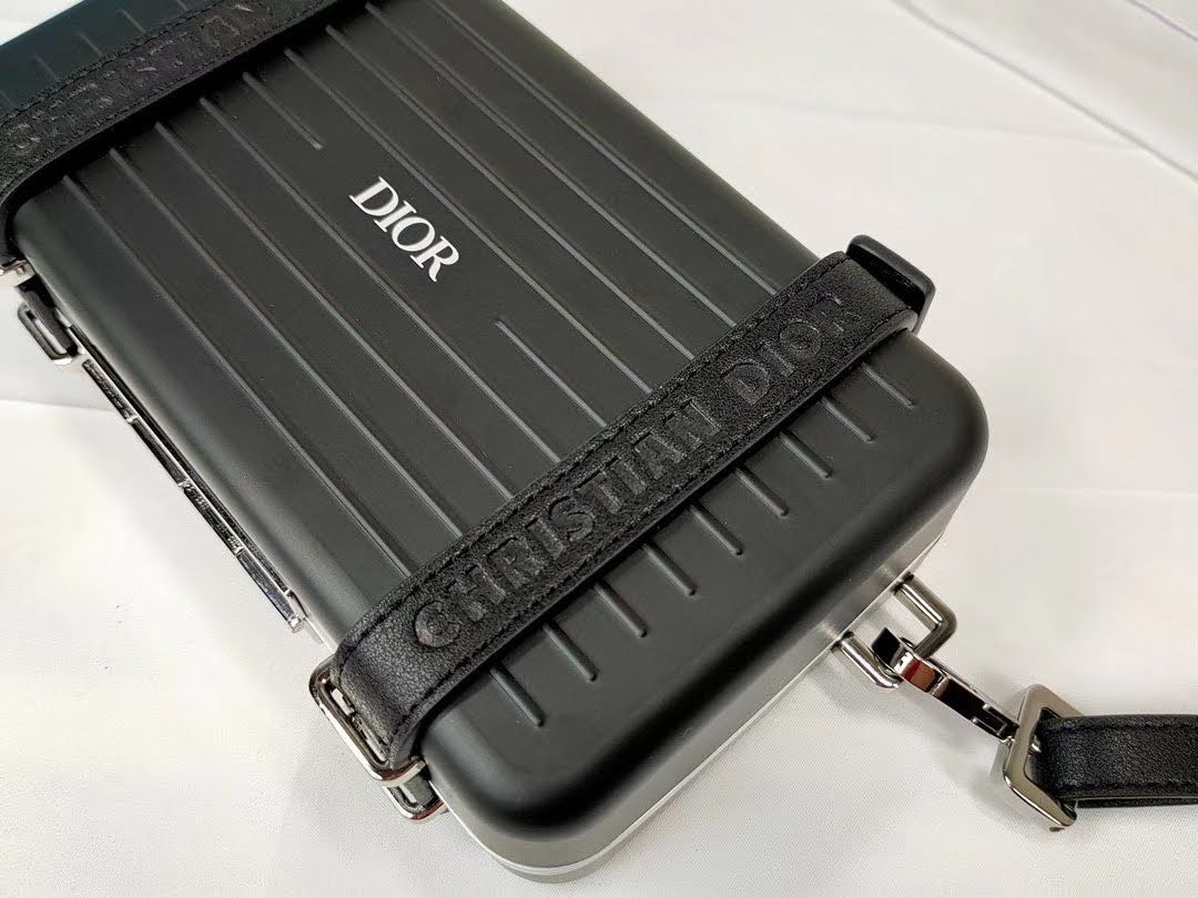 Presentation image of the black Dior x Rimowa aluminum clutch