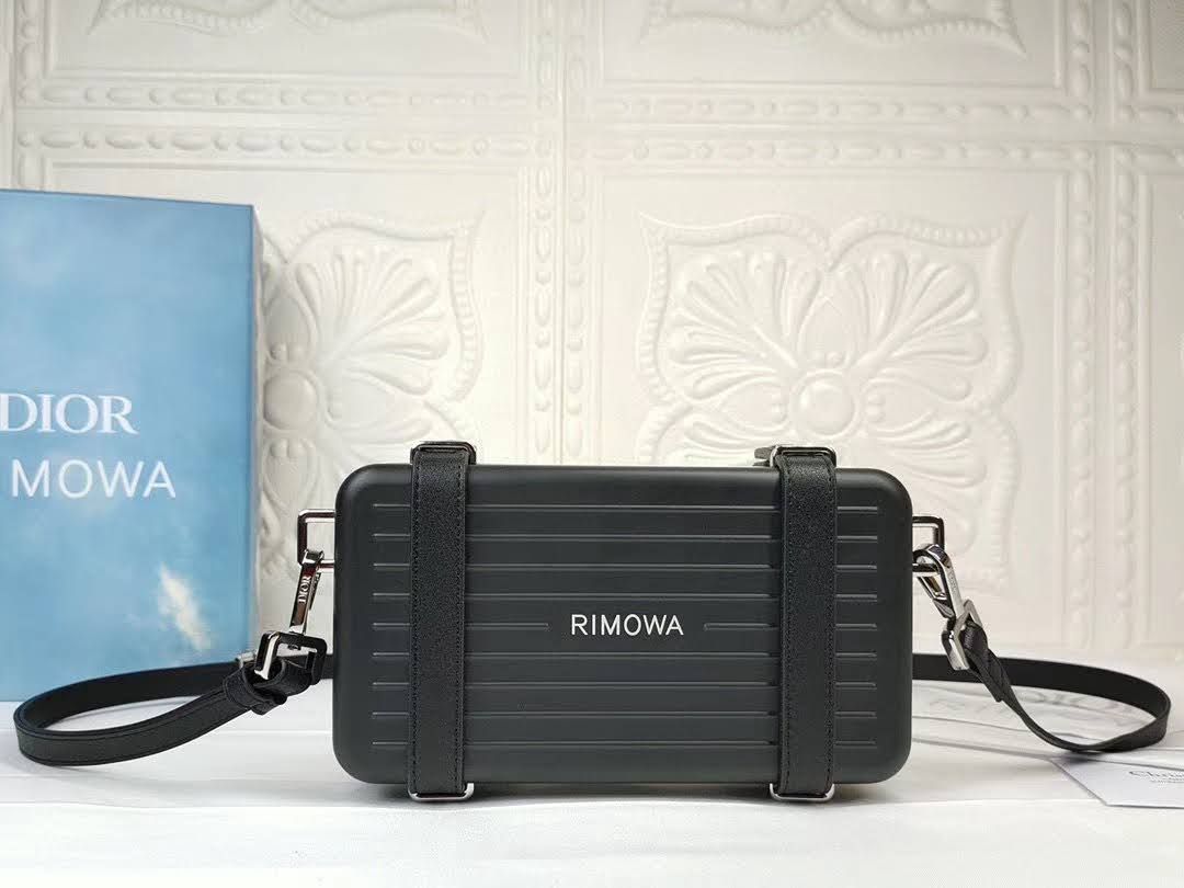 Presentation image of the black Dior x Rimowa aluminum clutch