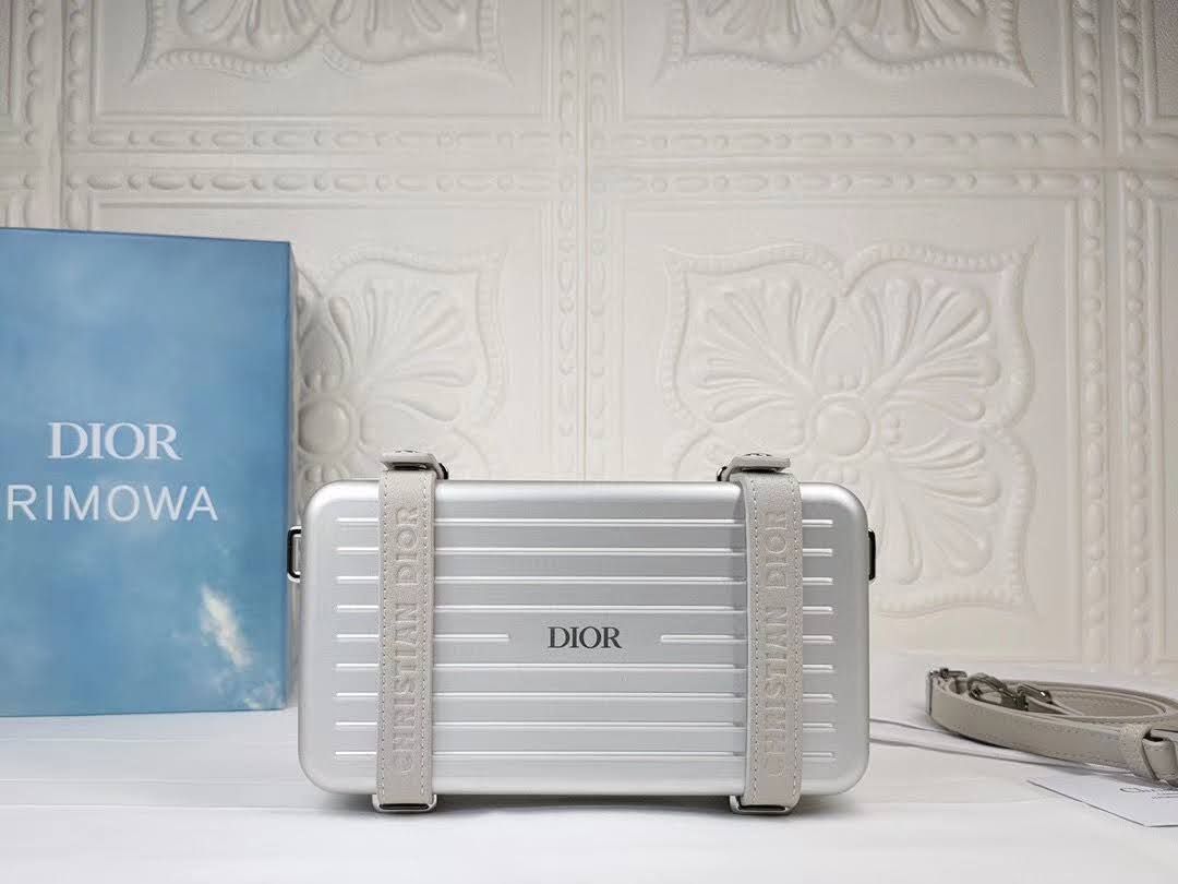 Presentation image of the gray Dior x Rimowa aluminum clutch