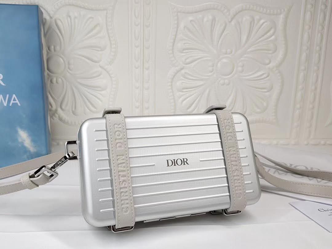 Presentation image of the gray Dior x Rimowa aluminum clutch