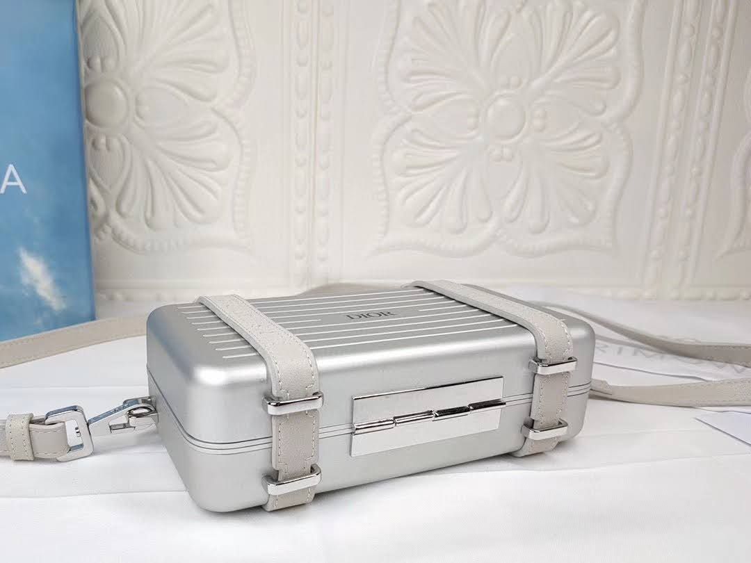 Presentation image of the gray Dior x Rimowa aluminum clutch bottom