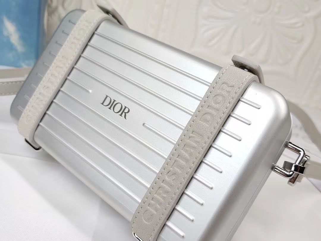 Presentation image of the gray Dior x Rimowa aluminum clutch