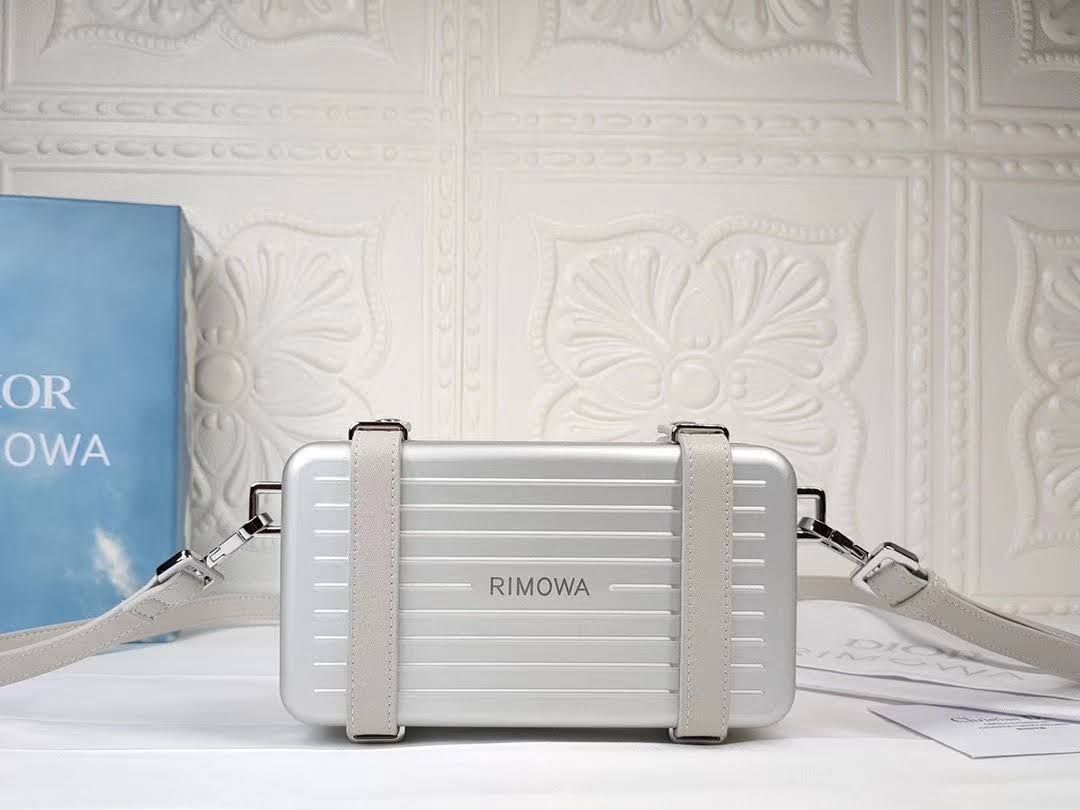 Presentation image of the gray Dior x Rimowa aluminum clutch