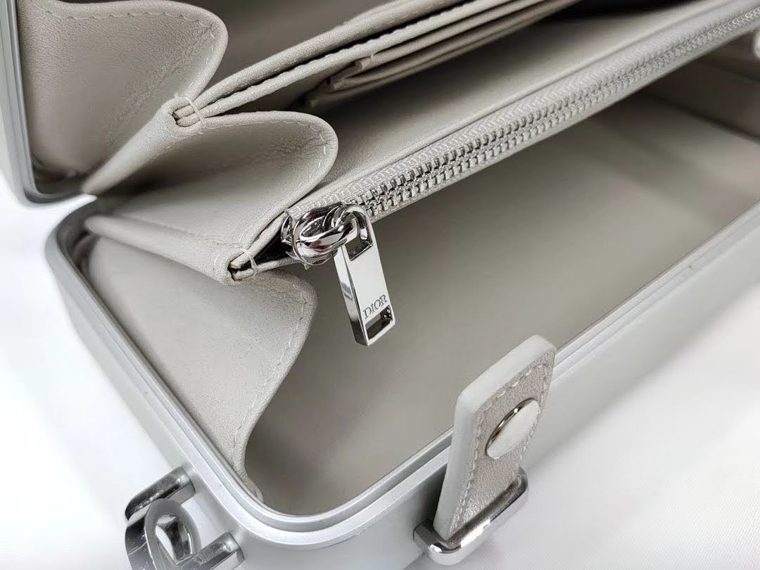 Presentation image of the gray Dior x Rimowa aluminum clutch interior zipper